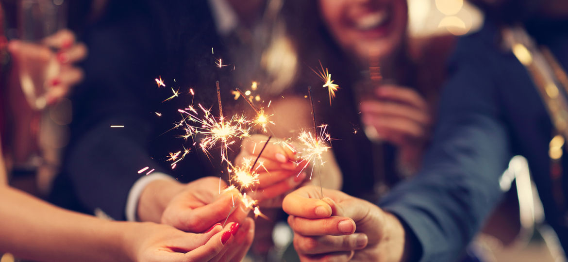 Group of friends having fun with sparklers