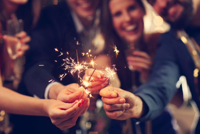 Group of friends having fun with sparklers