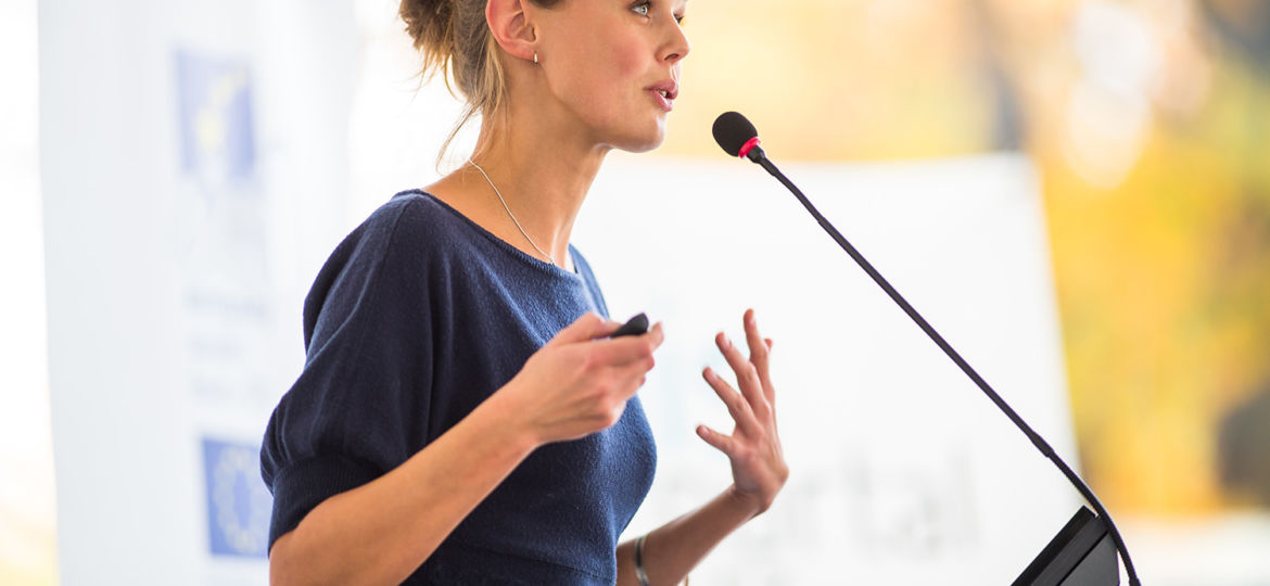 Pretty, young business woman giving a presentation in a conferen