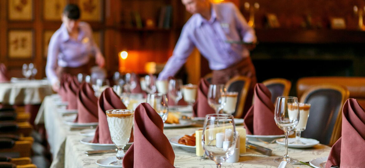 Waiters serve the table