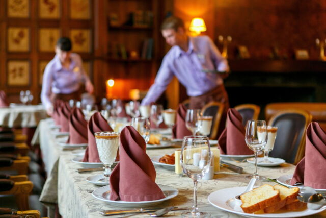 Waiters serve the table