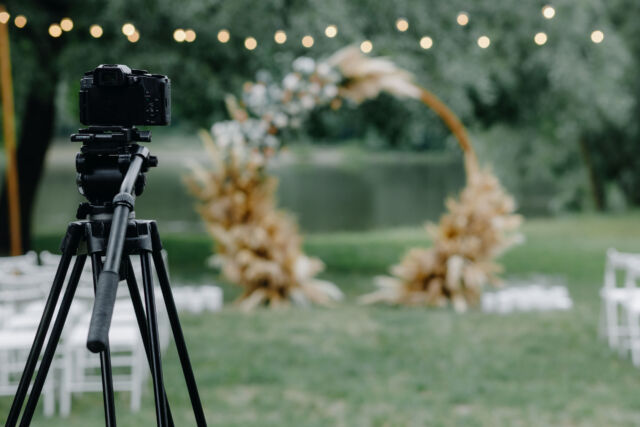 the camera stands on a tripod and shoots the wedding ceremony
