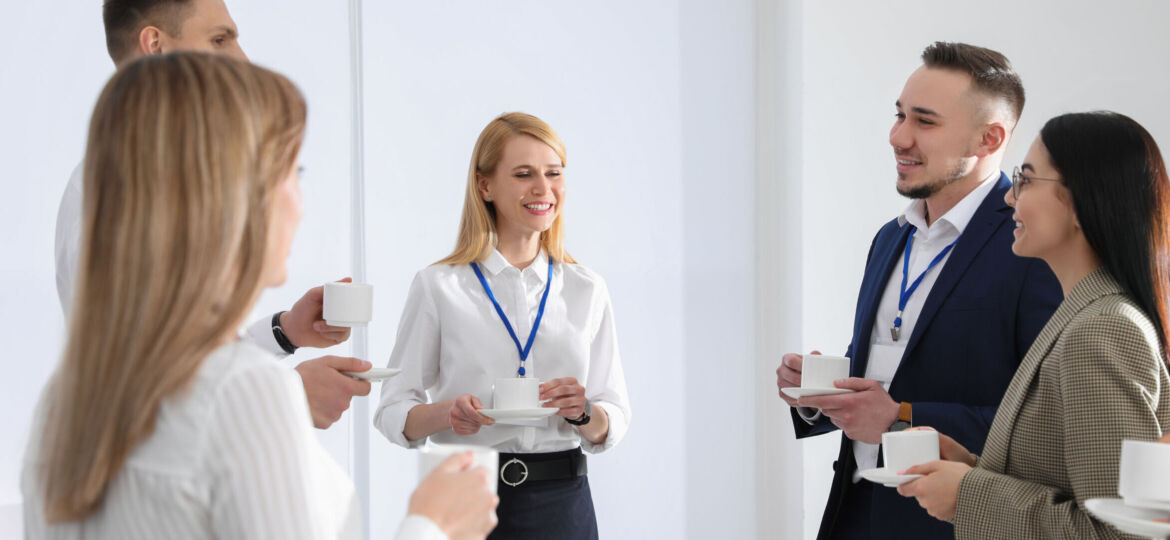 Group of people chatting during coffee break indoors