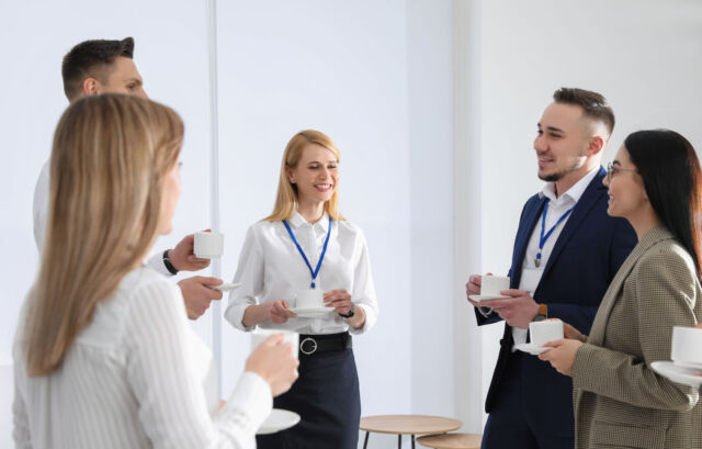 Group of people chatting during coffee break indoors