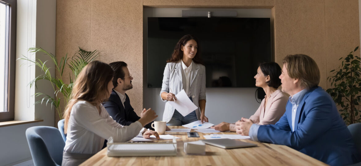 Confident young female business company leader holding office meeting