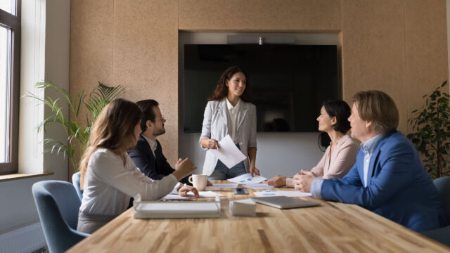 Confident young female business company leader holding office meeting