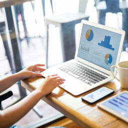 Cropped shot of female using laptop tom make a business plan at coffee shop