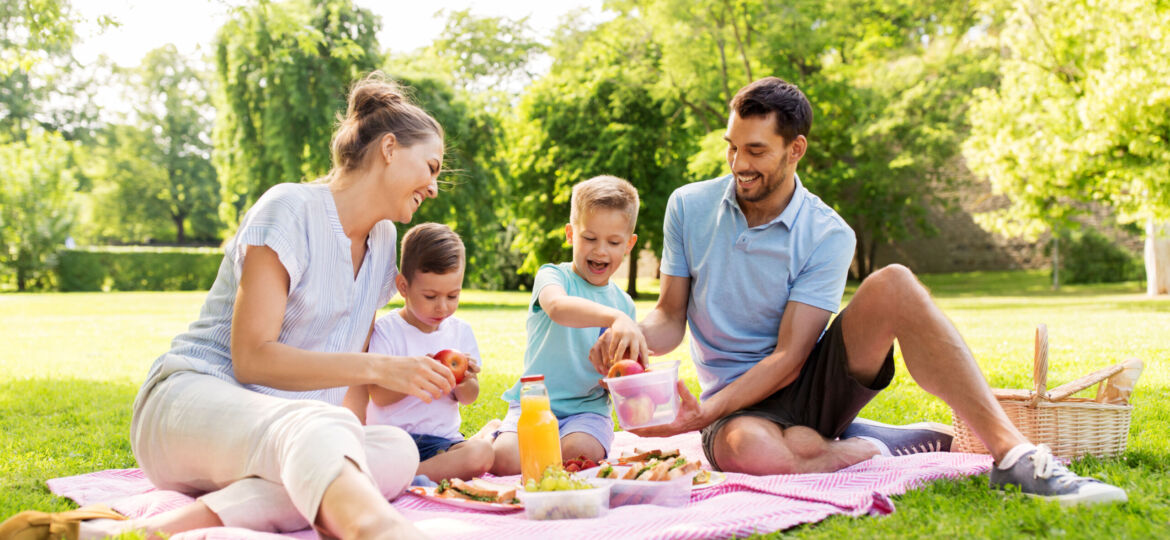 happy family having picnic at summer park