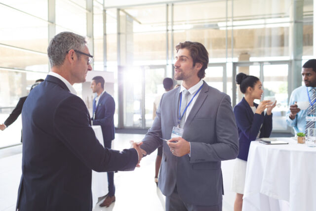 Business people shaking hand during a seminar