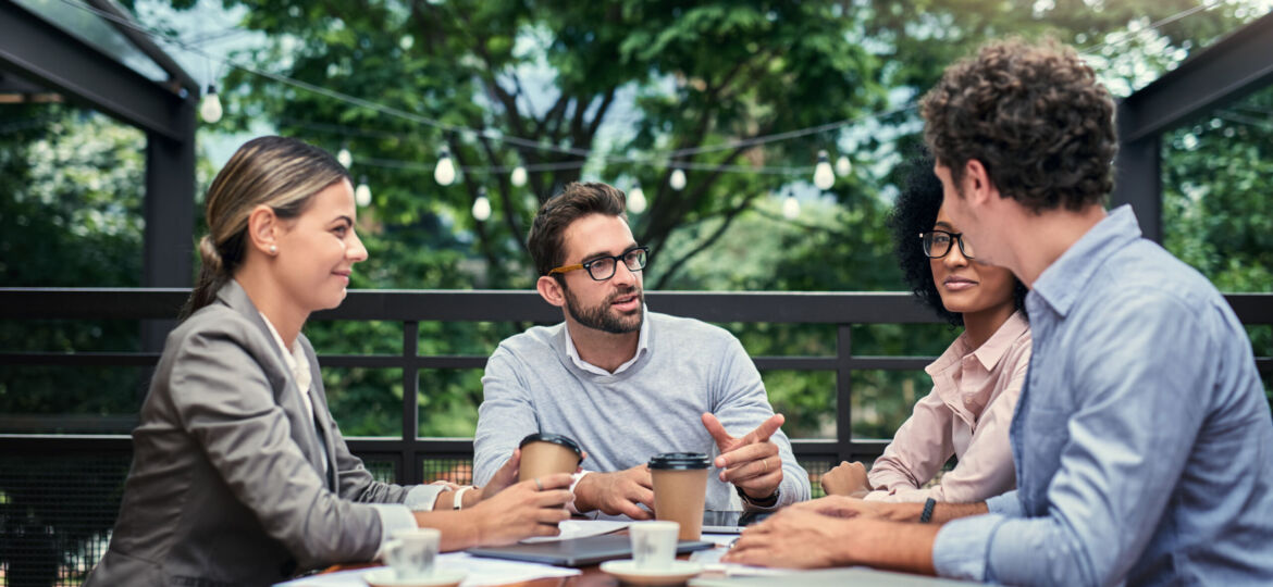 Location, location, location. Cropped shot of a group of business colleagues having a meeting outdoors at a cafe.