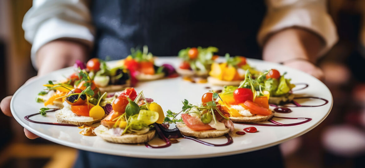 Waiter carrying a plate with delicious vegetarian food on some festive event, party or wedding reception